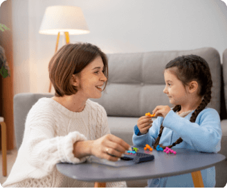 woman smiling at the little girl