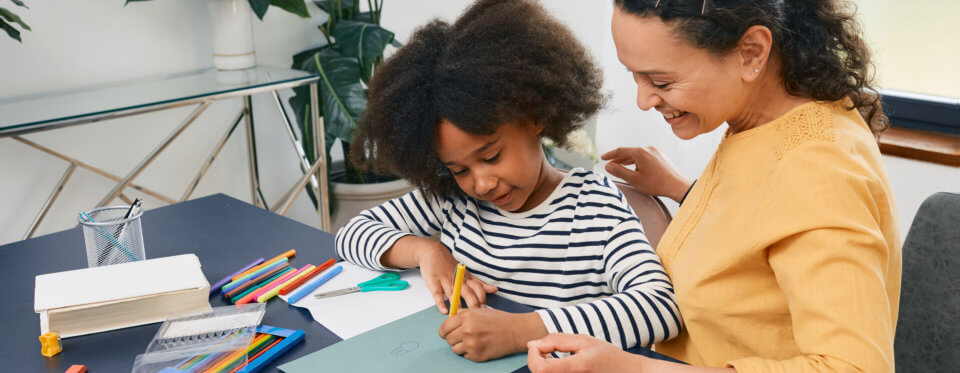 woman looking at the kids writing