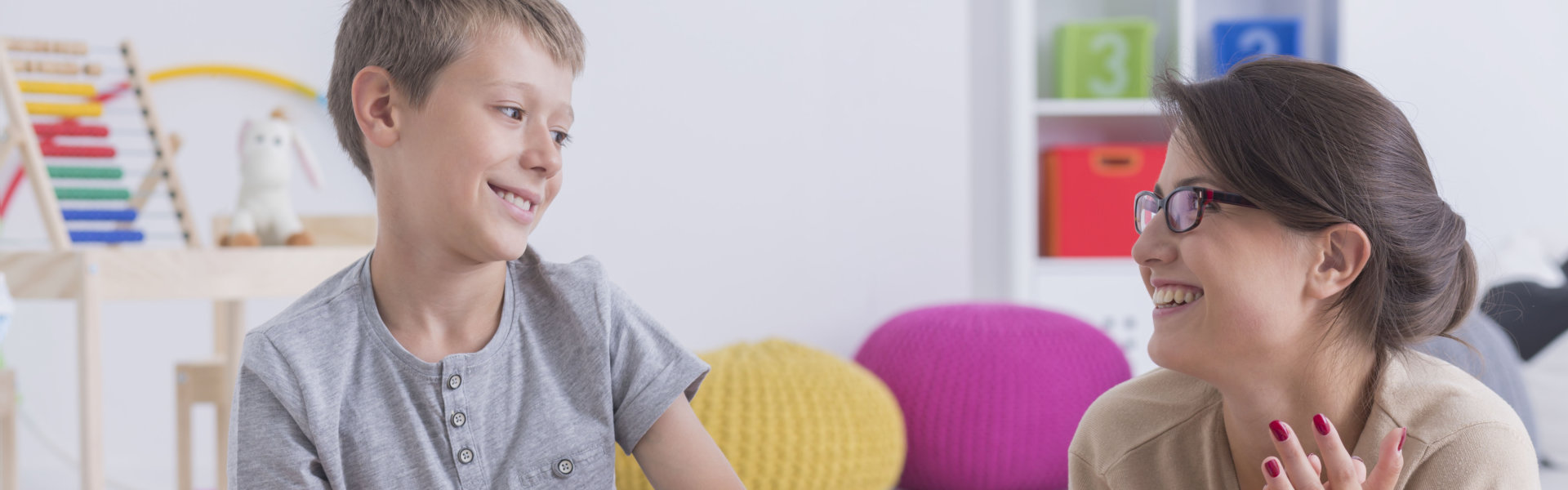 kid and woman smiling at each other