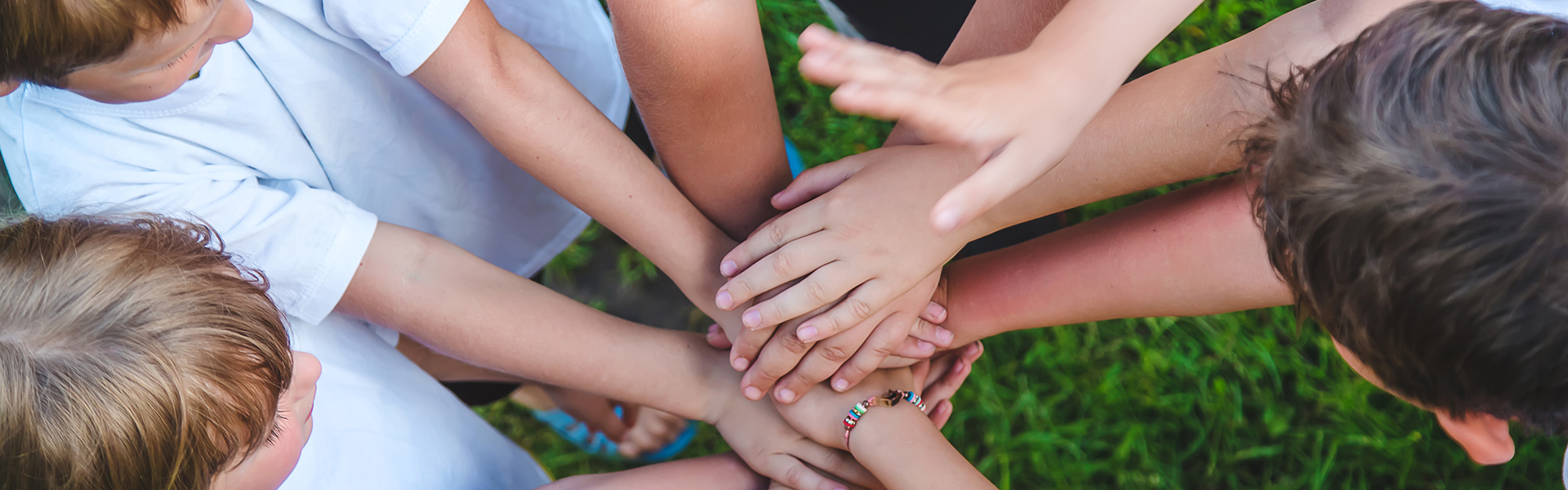 Children are playing with their hands clasped together